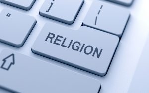 Religion word button on keyboard with soft focus
